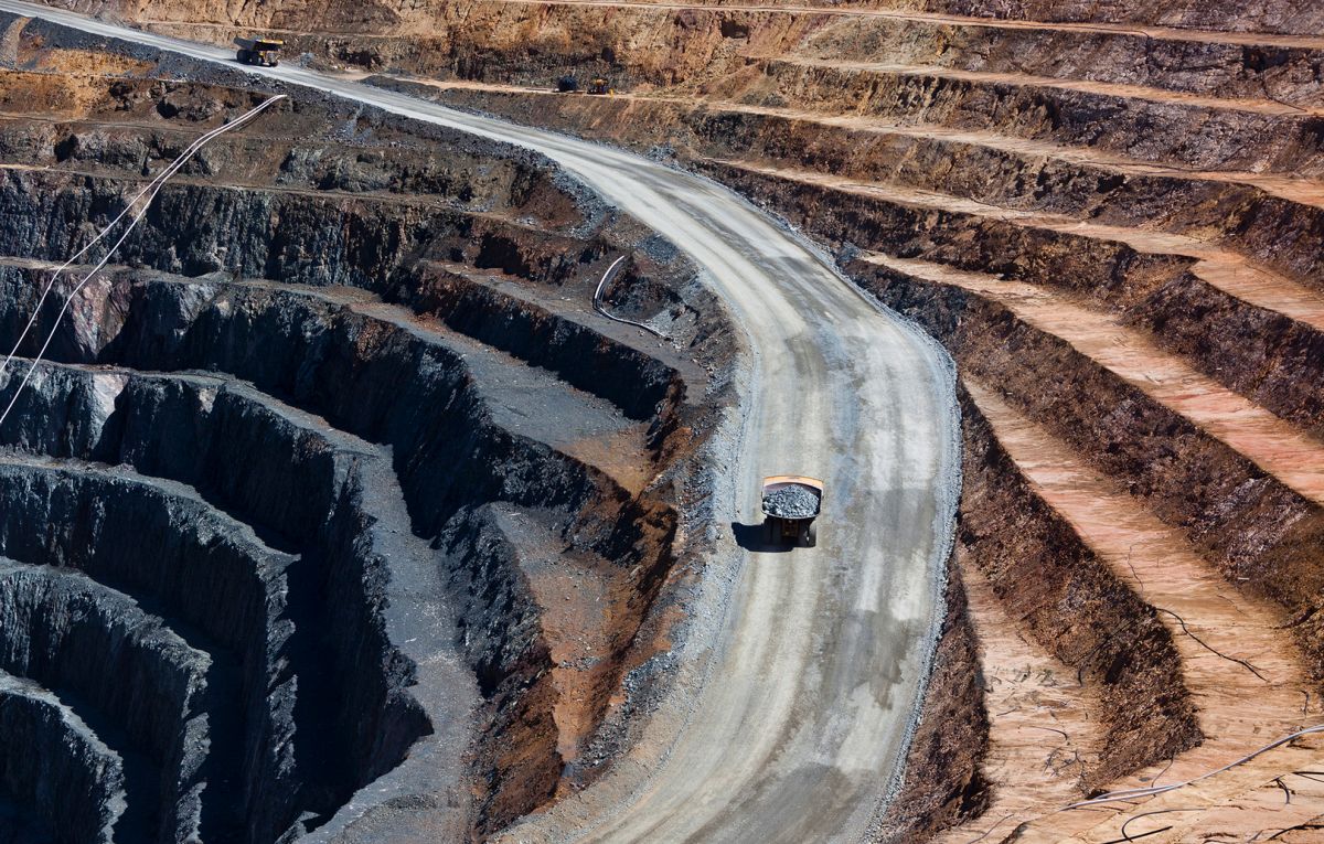 Two trucks transport gold ore from open cast mine. Barrick Cowal